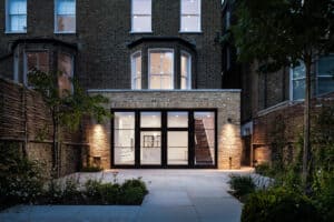 Maida Terrace House rear elevation at dusk with lights on